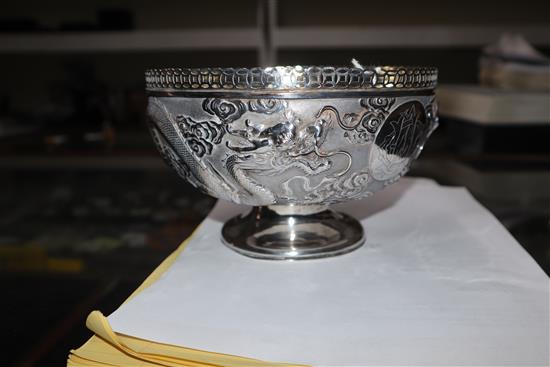 An early 20th century Chinese white metal pedestal bowl, embossed with dragons, 13.5 oz.